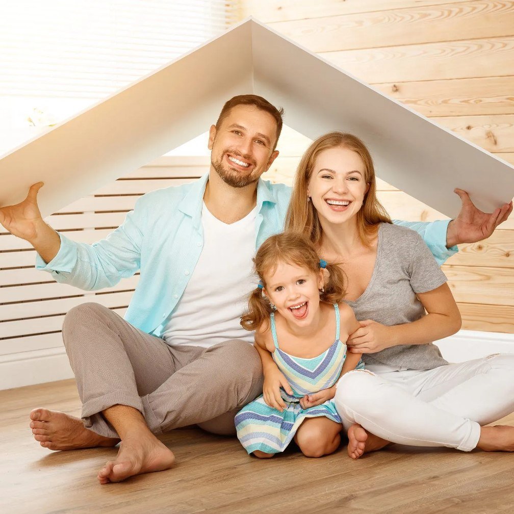 A family sheltering under a roof shape held above them, representing bundled home and auto coverage